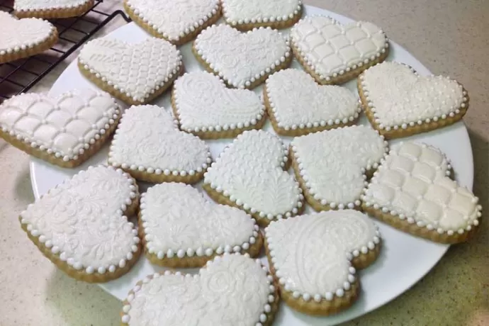 Plate of white heart-shaped cookies